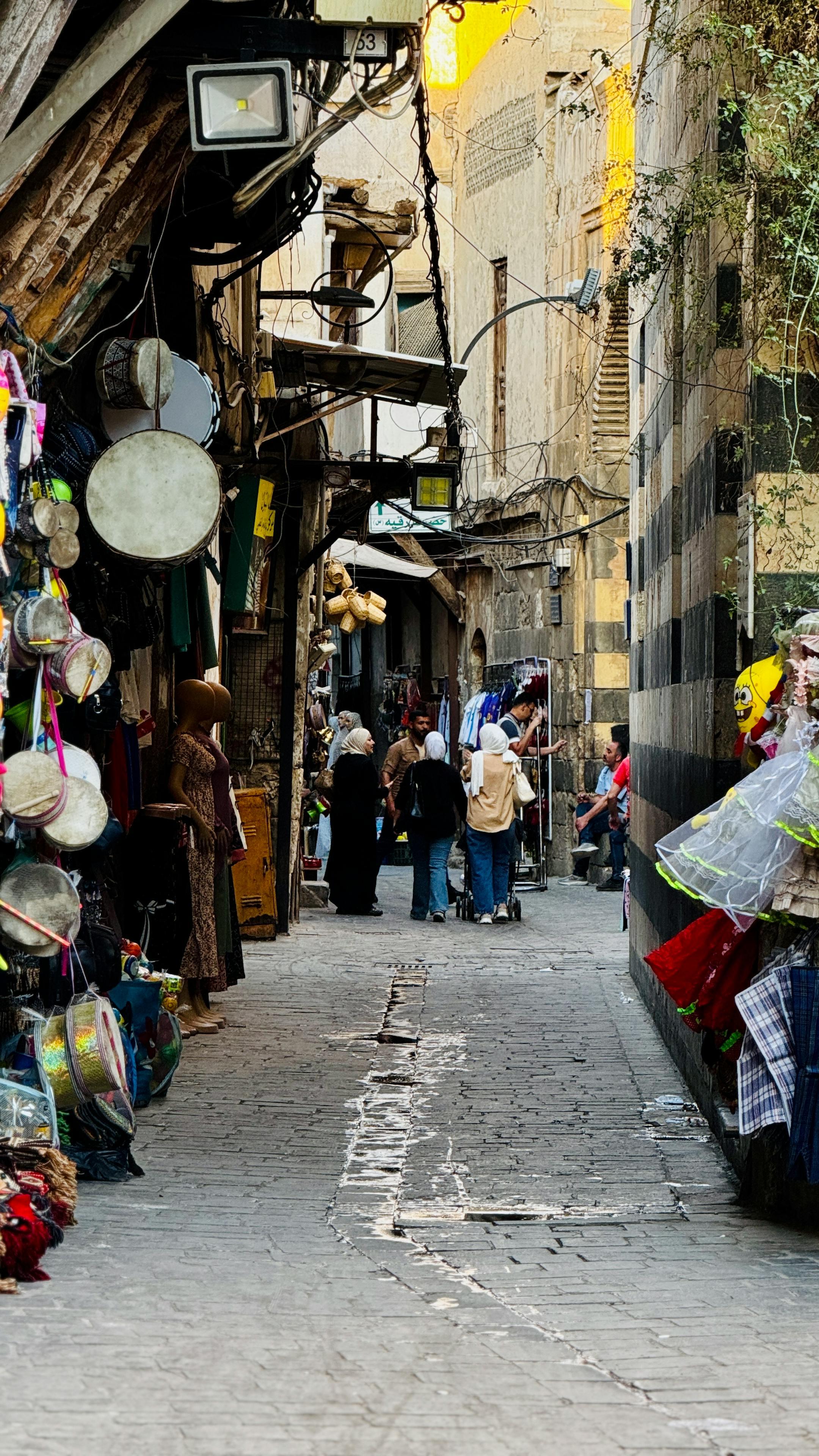 Explore the vibrant, narrow alley filled with shops in the historic Old Damascus market in Syria.