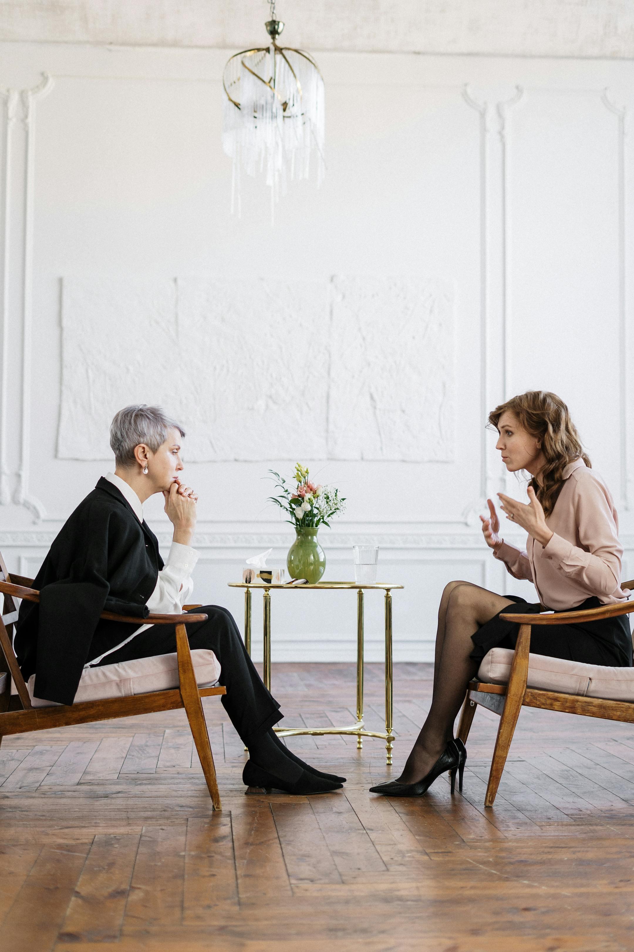 A Cognitive Analytica Psychotherapy Session Our Therapist and client are engaged in a counseling session in a bright, modern loft setting.
