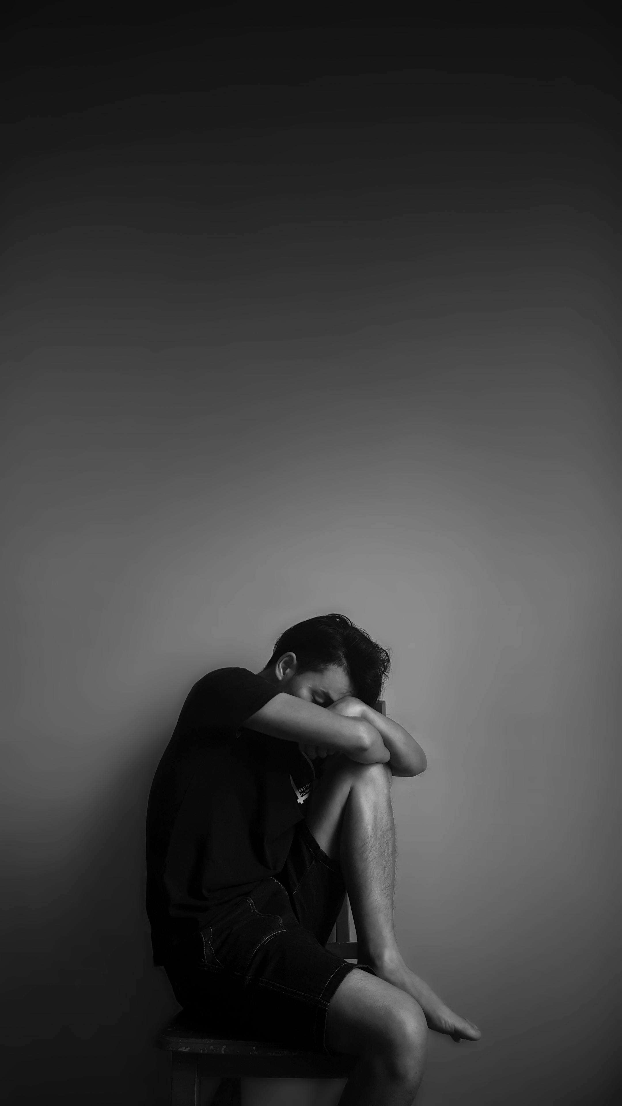 Black-and-white man sitting alone, reflecting depression, fatigue, and isolation — Cognitive Analytica, Lebanon