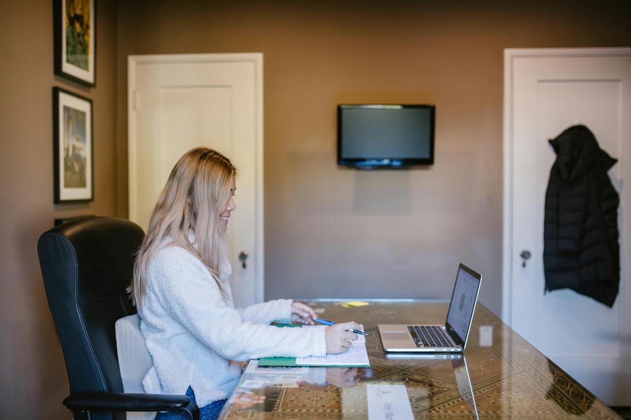 Cognitive Analytica psychotherapist conducting an online therapy session from home, focused on her laptop.<ul><li></li></ul>