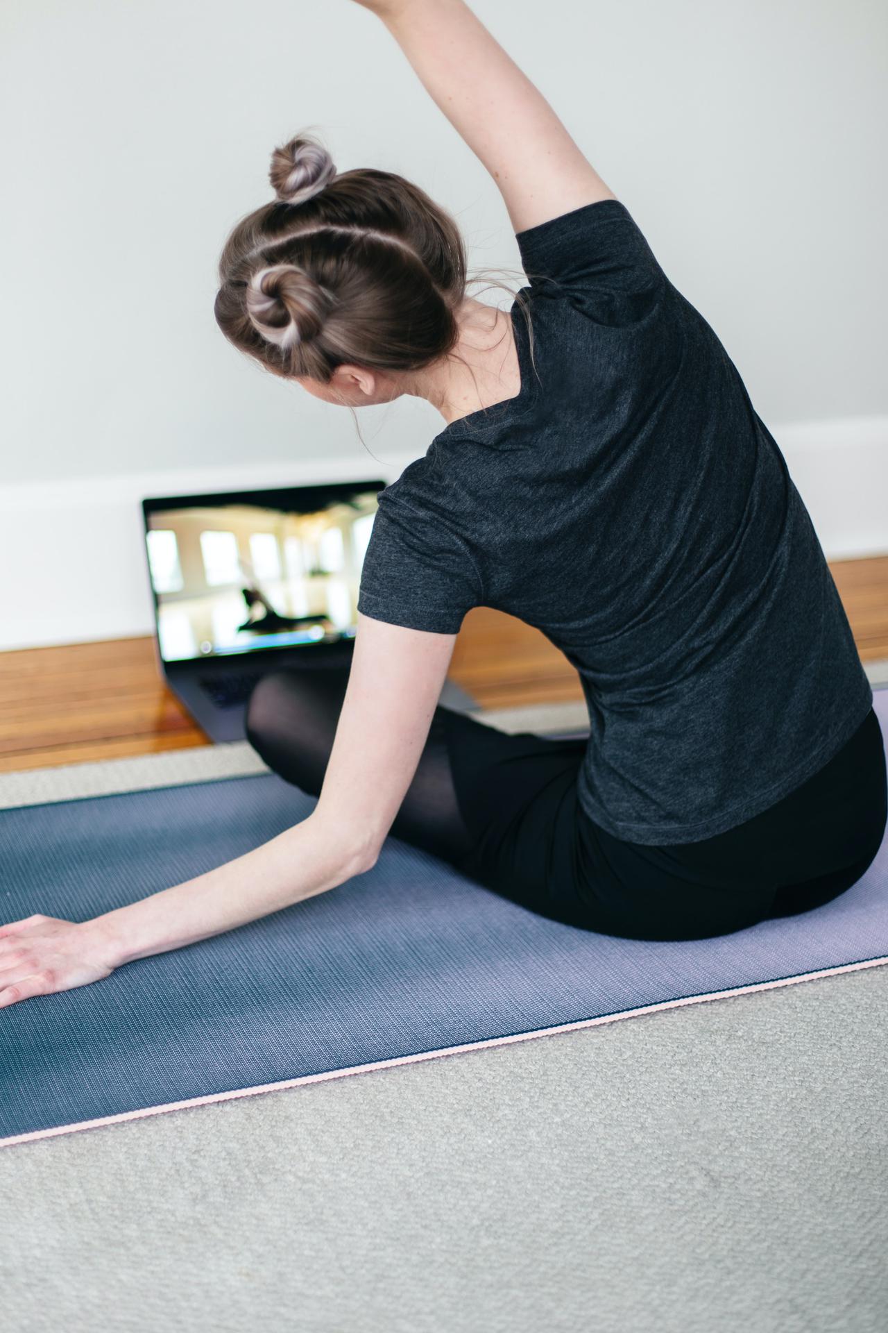 A woman taking a virtual fitness class.