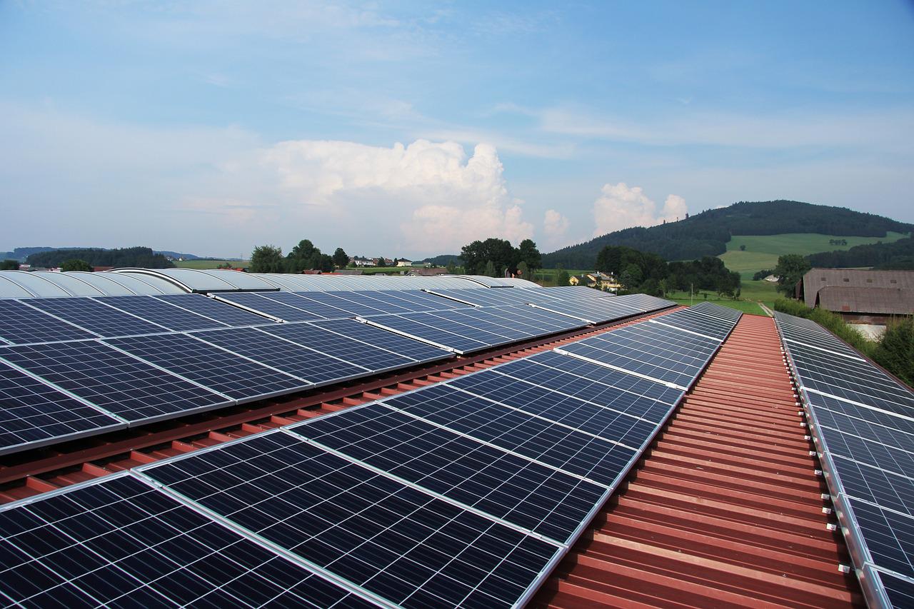 Rows of solar panels lined up on a red roof