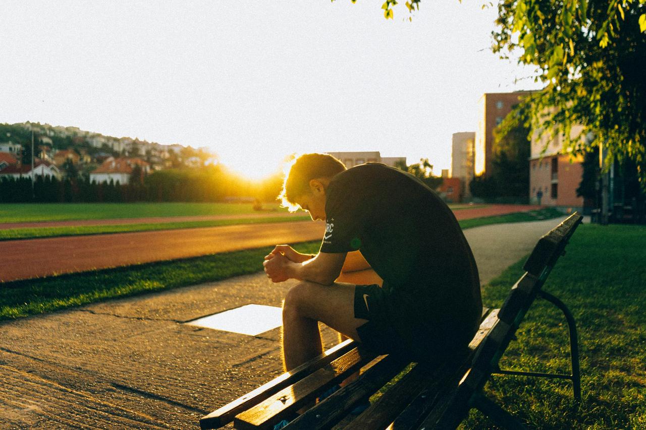 A man enjoying a quiet moment during sunset at a park in Slovakia, conveying leisure and relaxation.