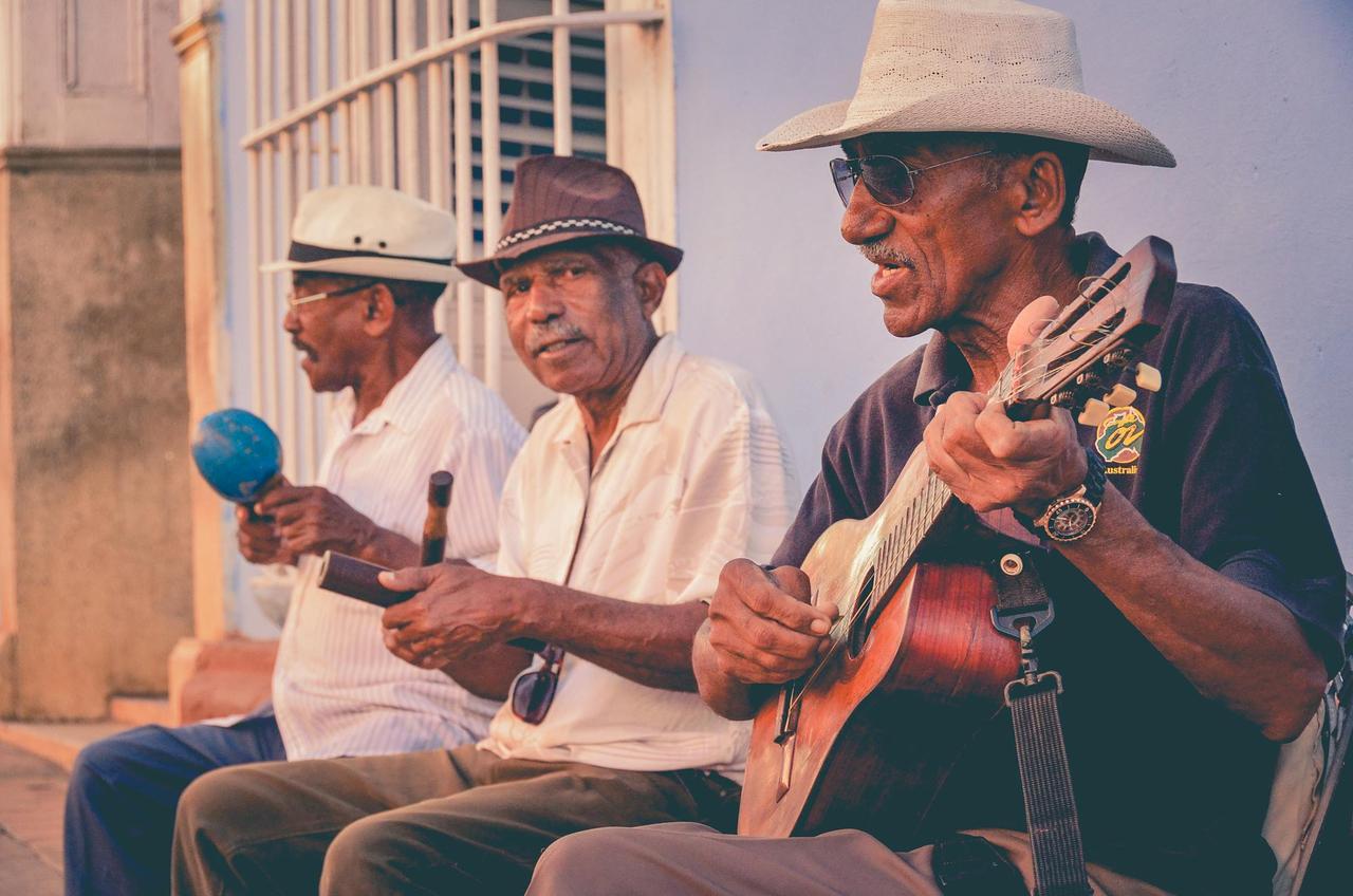 A lively street performance by elderly musicians in Cuba showcasing traditional rhythms and instruments.