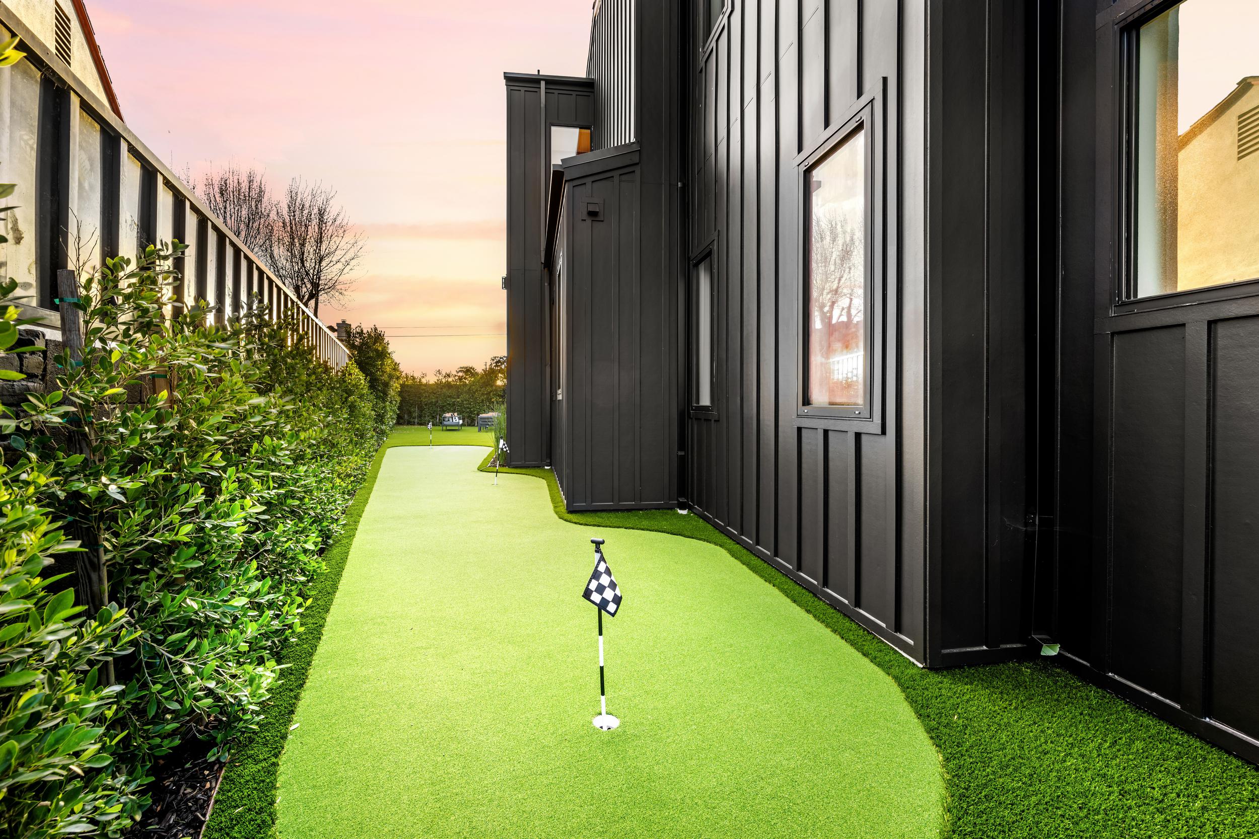 backyard-mini-golf-course-beside-a-modern-black-ho-2025-02-10-06-40-45-utc.jpg