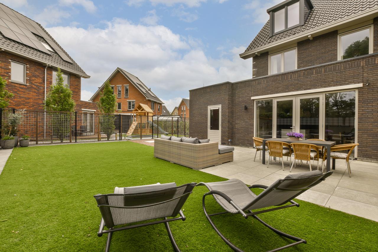 the-backyard-of-a-house-with-chairs-and-a-patio-2025-02-12-01-35-12-utc.jpg