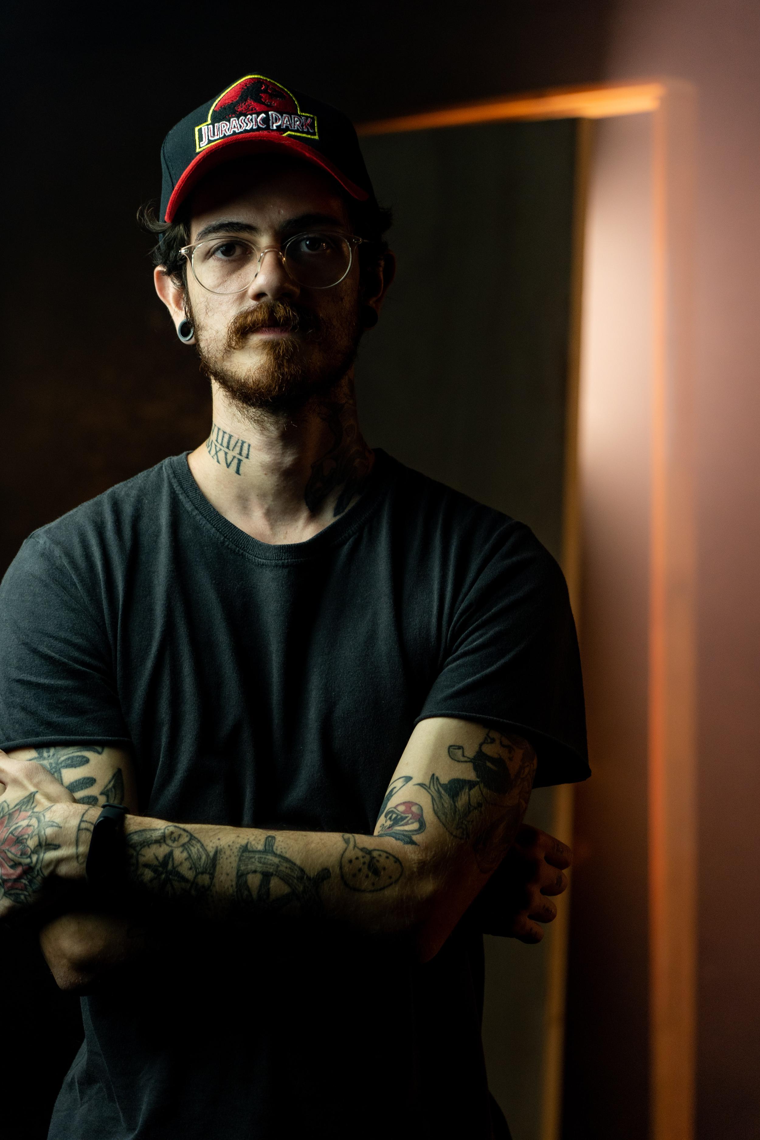 A man with a cap and tattoos staring into the camera. Medication management in Portland, OR can revolutionize your life.