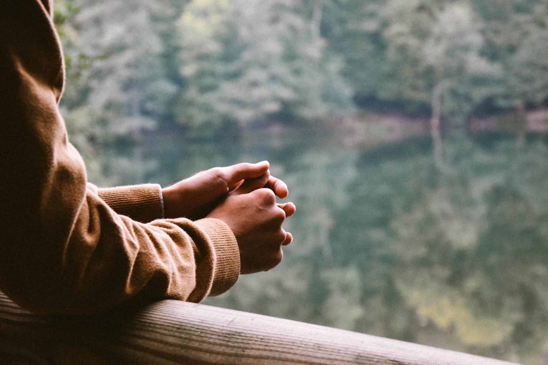 Image of a woman looking at a lake in peace after working with a psychiatric nurse practitioner for medication management.