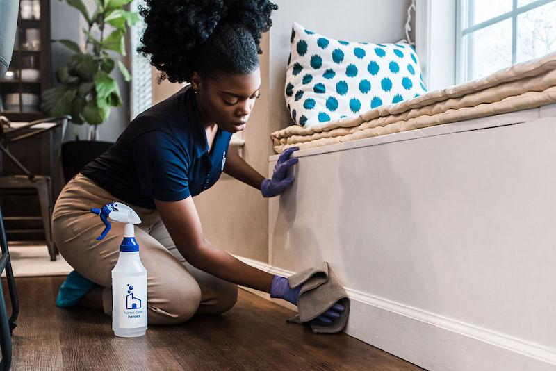 home-clean-heroes-cleaner-wiping-down-baseboards.jpg