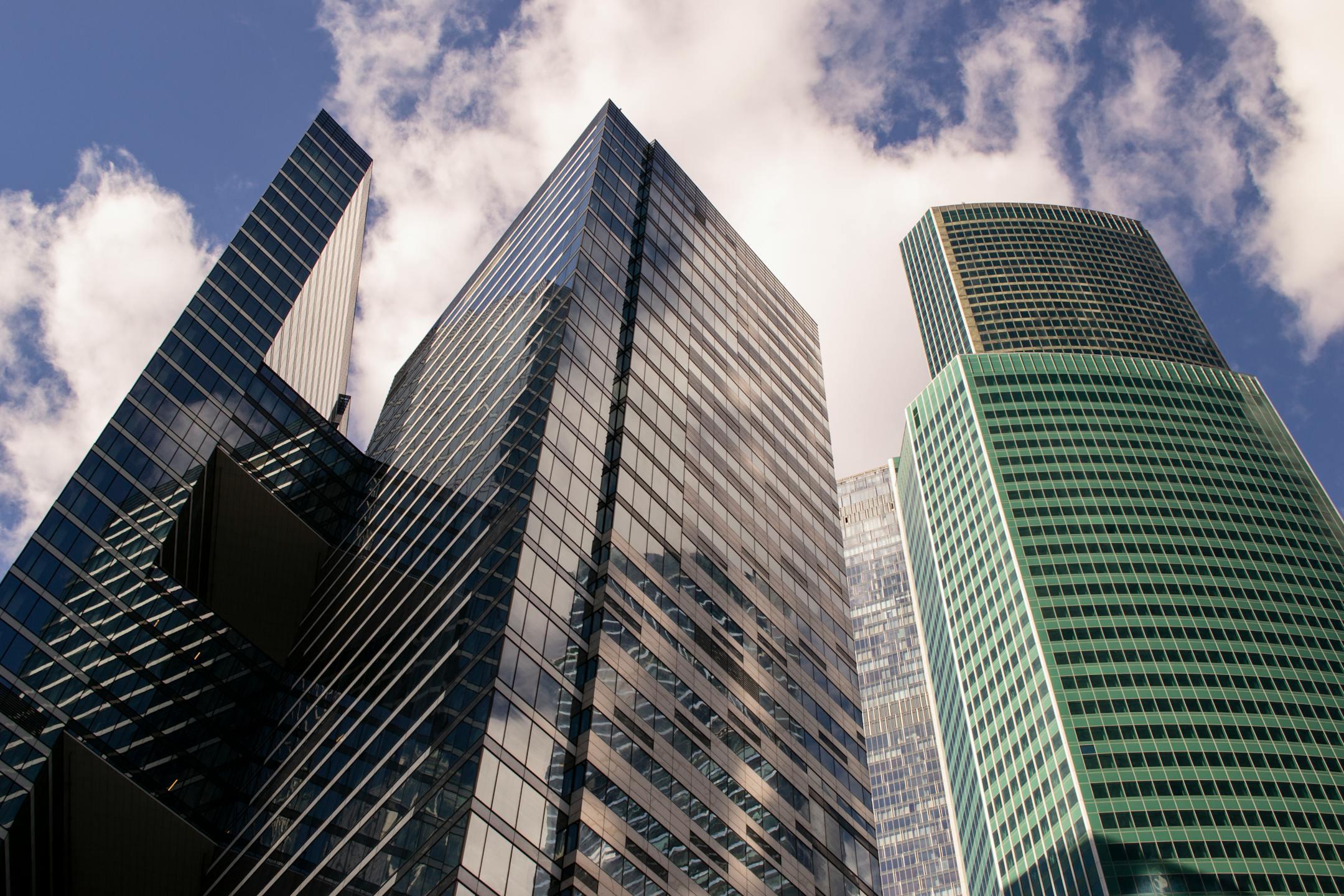 A dramatic view of Moscow's modern skyscrapers against a bright sky, showcasing urban architecture.