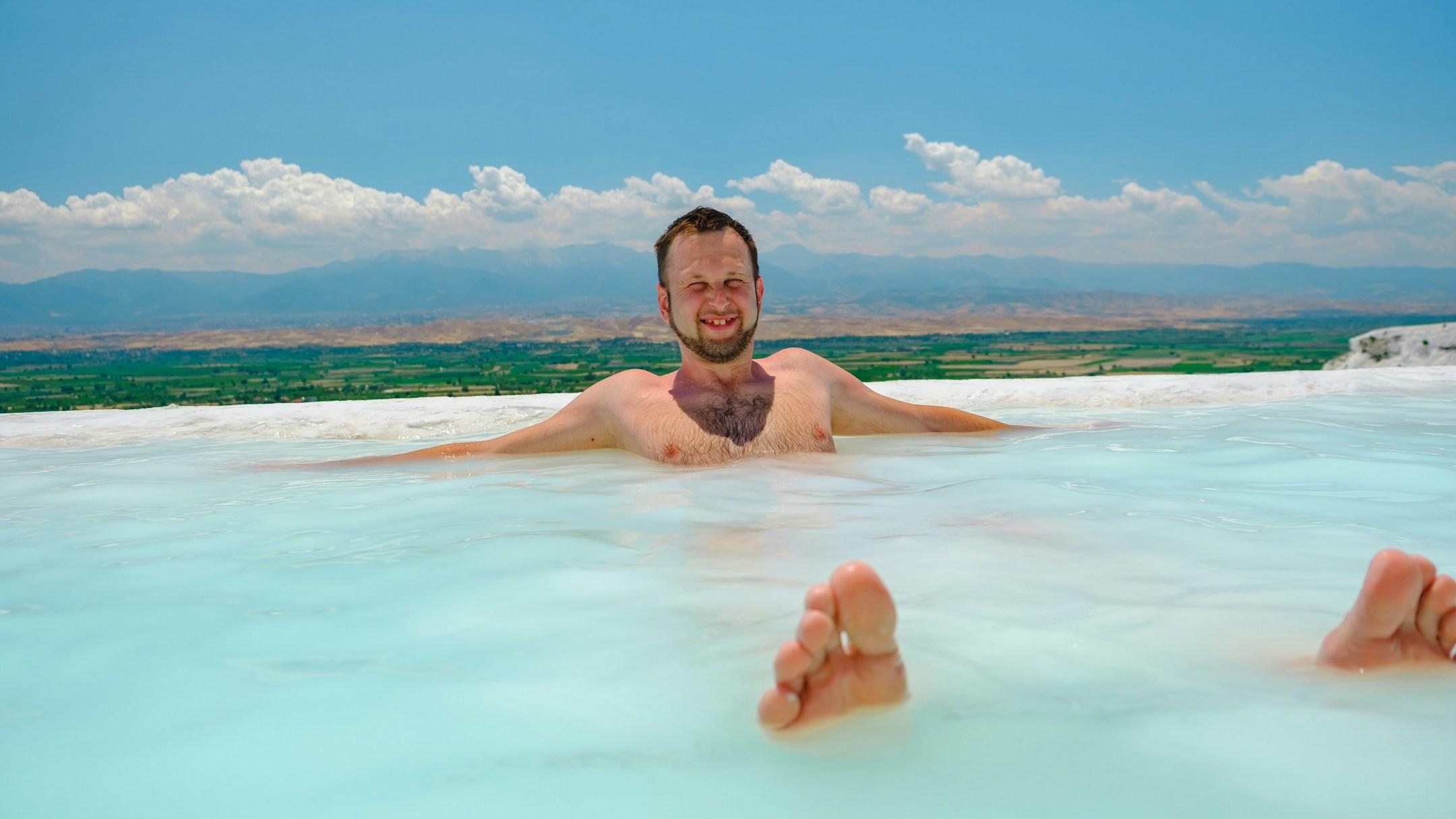 Man Enjoying Pool Pamukkale, Turkey - Joyful Traveler Relaxing in the Natural Hot Springs of Pamukkale, Turkey.