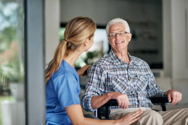 Caregiver actively engaging with a senior in a bright, comfortable home