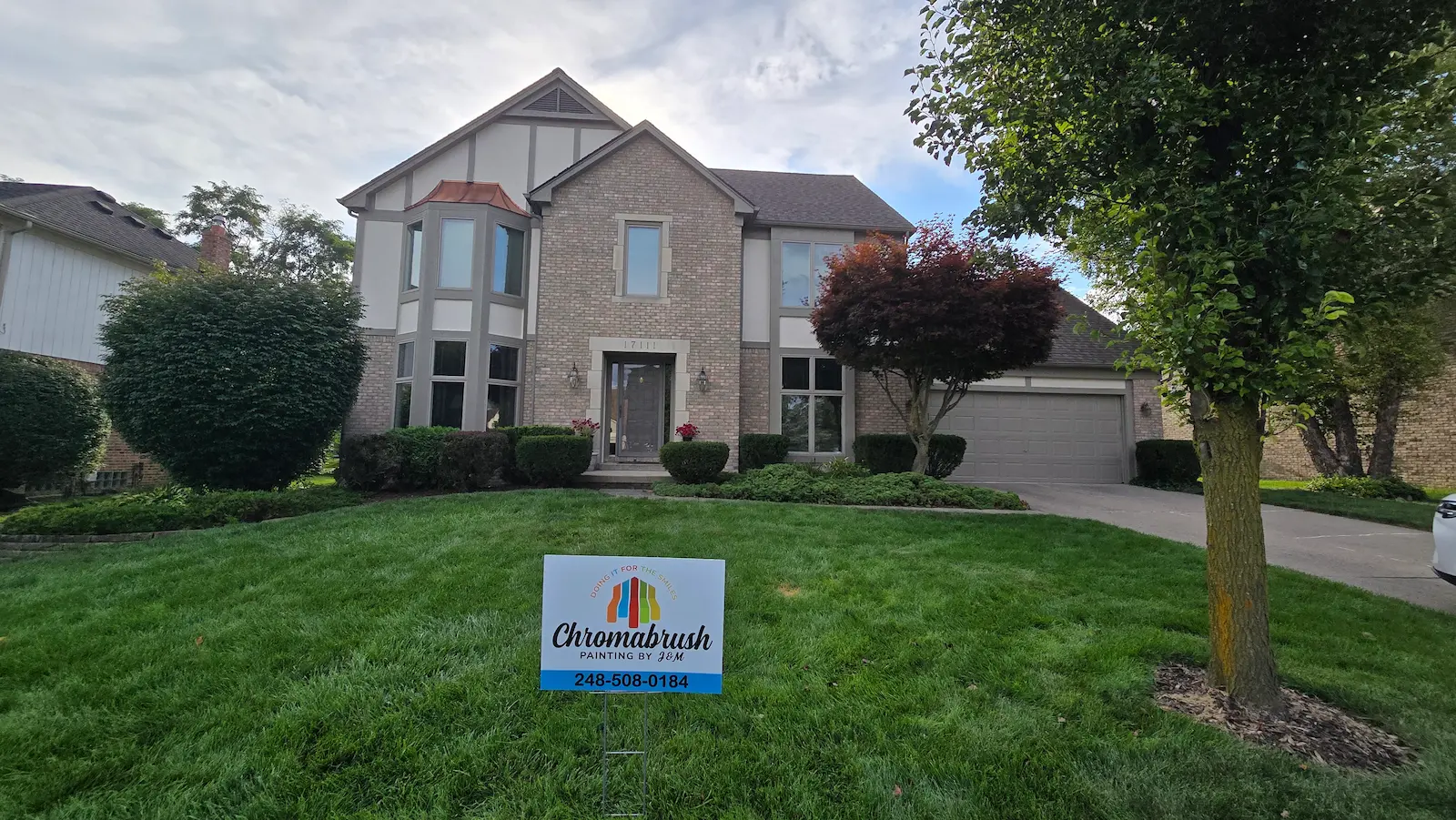 Northville Tudor exterior painting by Chromabrush Painting using Sherwin-Williams Natural Tan siding and Studio Clay trim