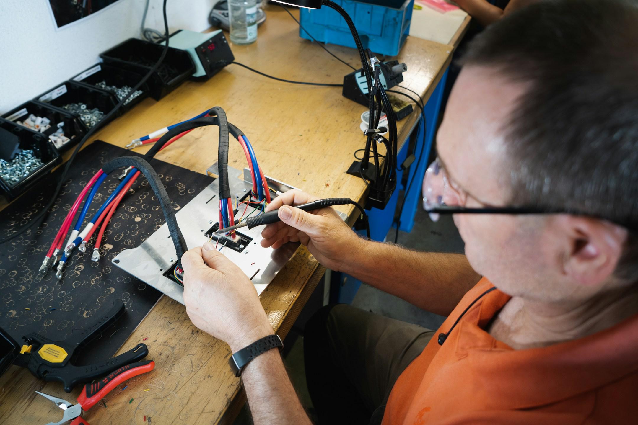 Soldering our wire harness for Kumpan electric scooters. 💚
