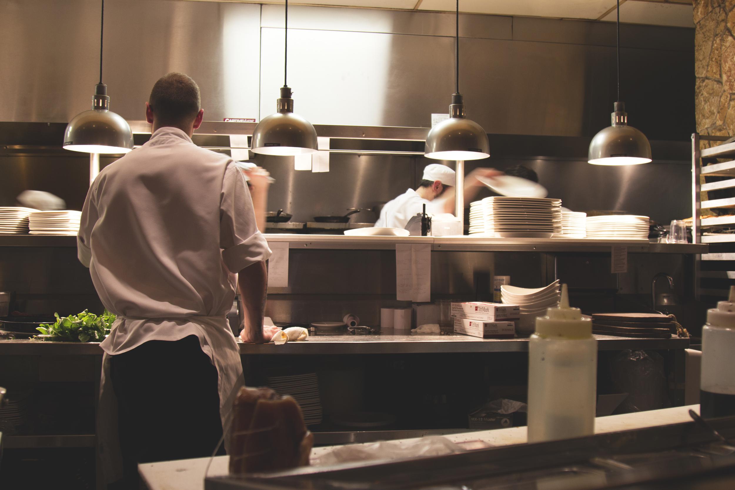 man standing by kitchen with turned on lights