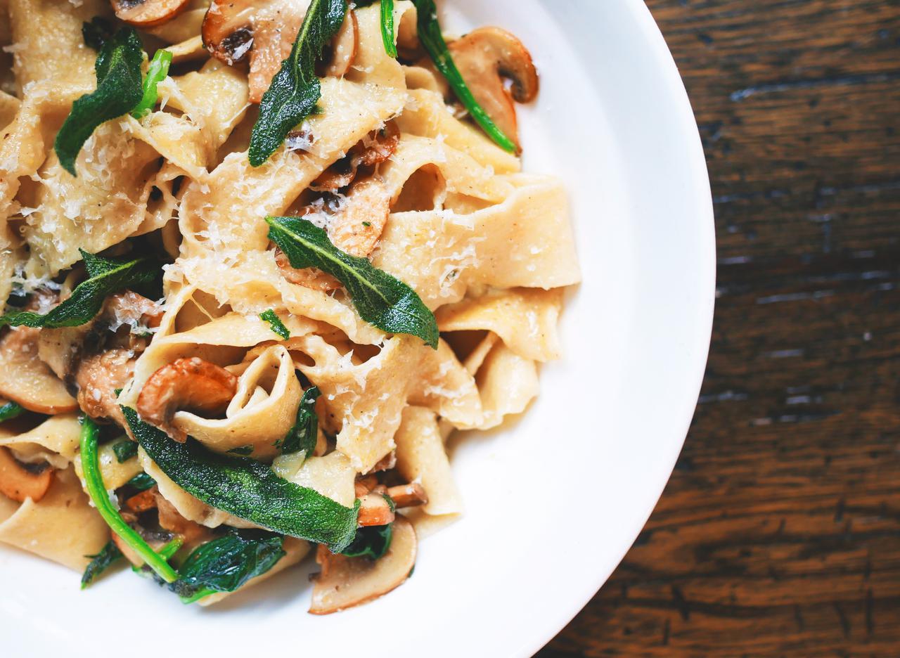 pasta with vegetable on white ceramic round plate