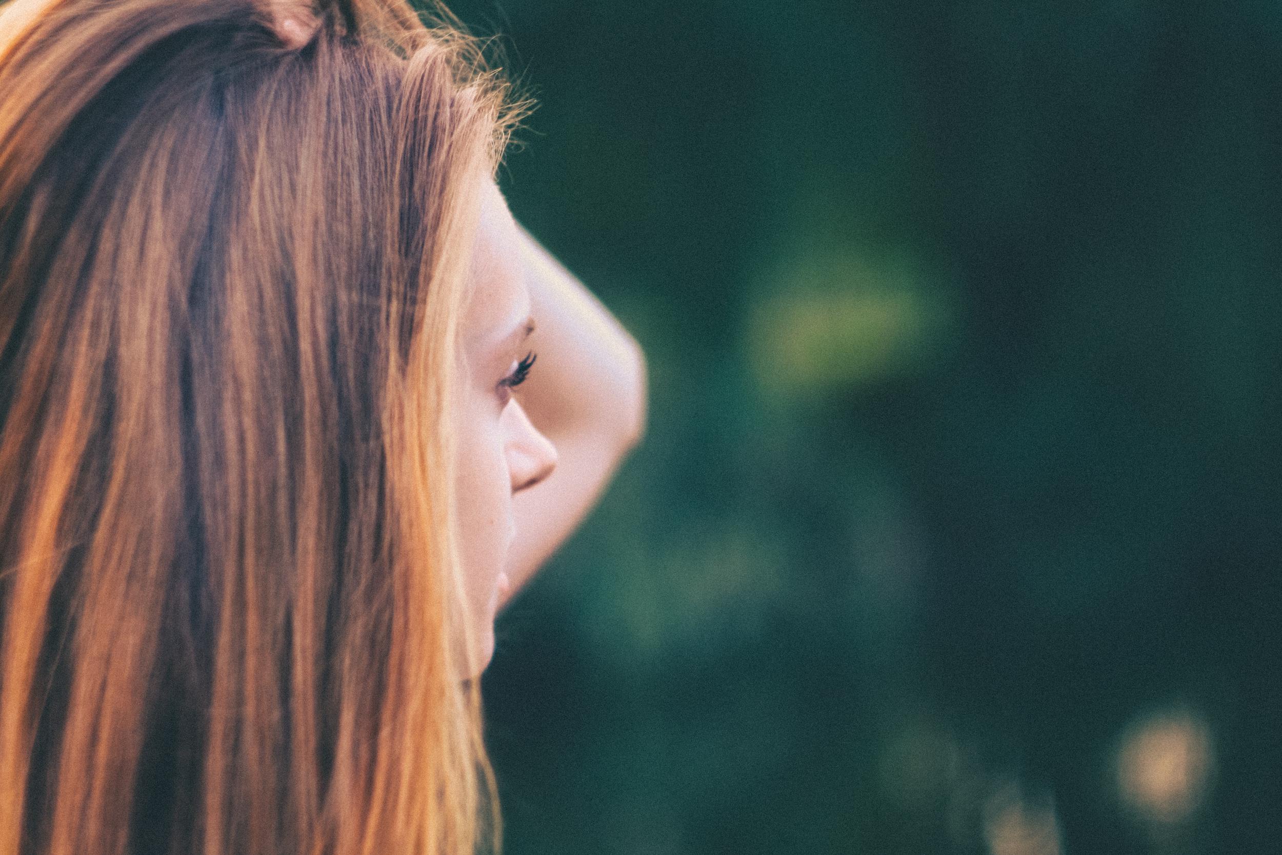 woman holding her hair macro photography