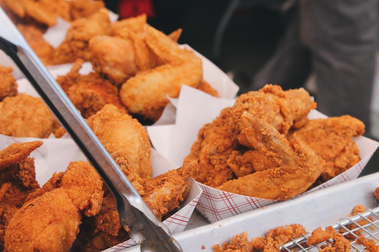 brown fried chicken wings on white serving paper during